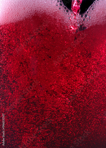 Close-up of red wine bubles in a transparent glass on black backgrond