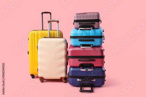Many suitcases on pink back...