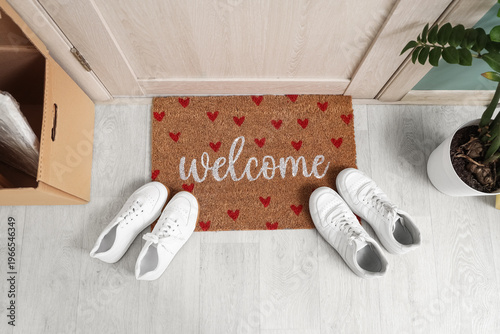 Doormat with sneakers in ha...