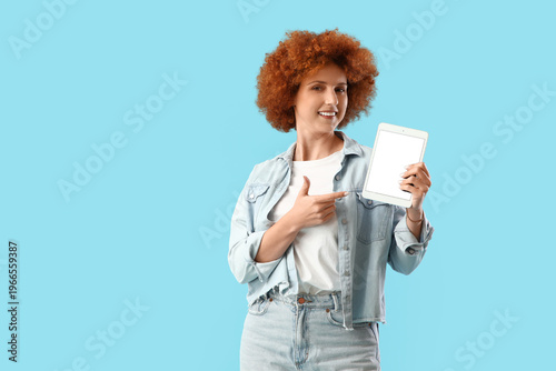 Smiling redhead woman point...