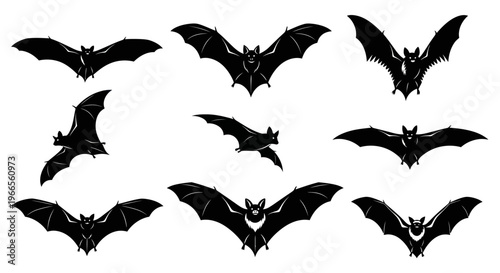 Several black bats are flying in the air.
