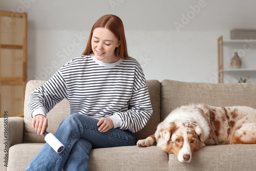 Young woman with lint rolle...