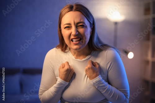 Angry mature woman in bedroom at night. International Stress Awareness Week