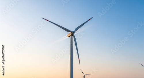 Wind Turbine Against a Clear Blue Sky at Sunset.