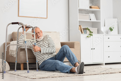 Senior man sitting on floor...