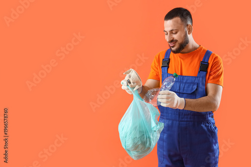 Bild auf Leinwand Male scavenger throwing garbage into bag on orange background