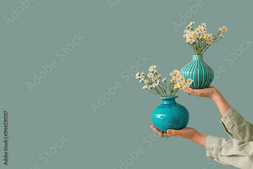 Female hands and vases with...
