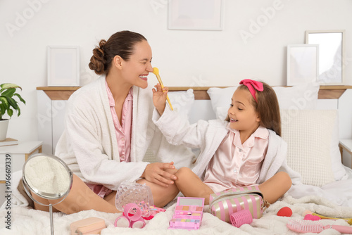 Happy young woman with daug...