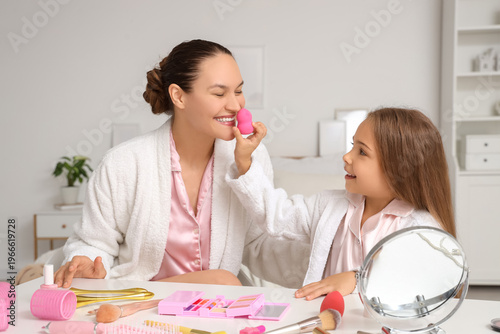 Happy young woman with daug...