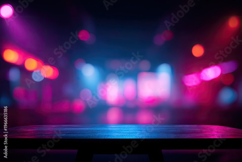 Empty stage with vibrant pink and blue lights creating a festive atmosphere