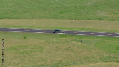 Following SUV on country road along farmland midwest kansas