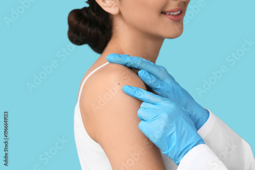 Dermatologist examining mol...