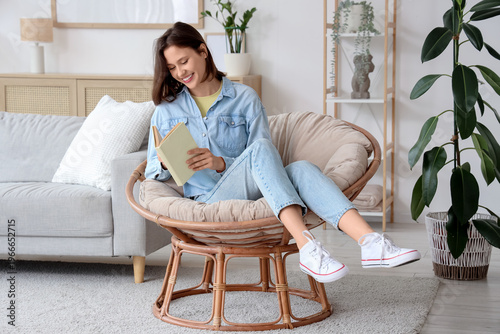 Young woman reading book in...
