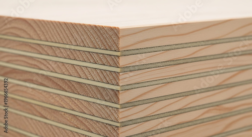Close-up view of stacked layers of plywood, showcasing its wood grain and construction