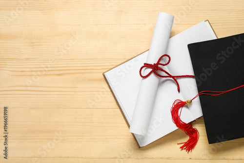 Graduation hat, book and di...