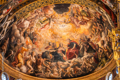 Ornate Renaissance fresco of the Coronation of the Virgin Mary surrounded by angels on the domed ceiling of a church in Parma, Italy 06.01.2026.