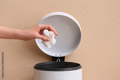 Woman throwing white crumpl...