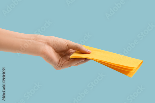 Female hand with yellow pap...