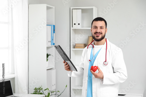 Young happy male doctor wit...