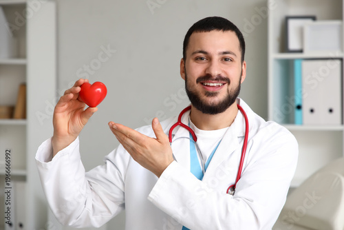 Young happy male doctor wit...