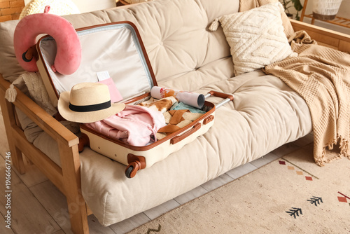 Unpacked suitcase with clot...