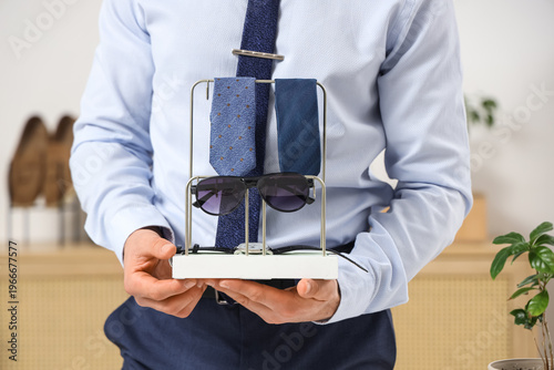Man holding stand with styl...