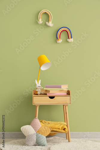 Lamp with toy and books on ...