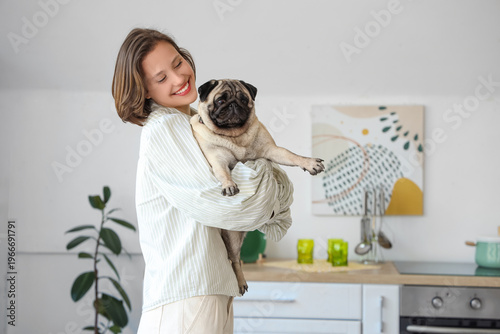 Young woman holding cute pu...