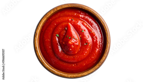 Overhead shot of a small wooden bowl filled with vibrant red tomato sauce
