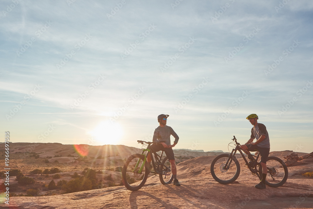 Fototapeta premium People, mountain bike or relax in nature with scenic view, adventure or endurance training for fitness. Space, friends and cycling break with bicycle, helmet or sunshine outdoor for exercise together