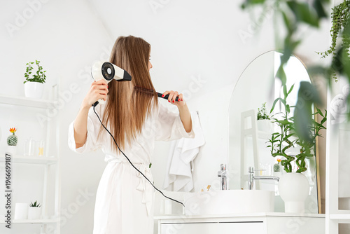 Beautiful young woman dryin...