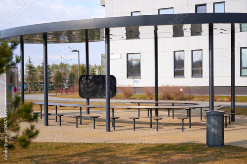Empty picnic tables under canopy in outdoor area