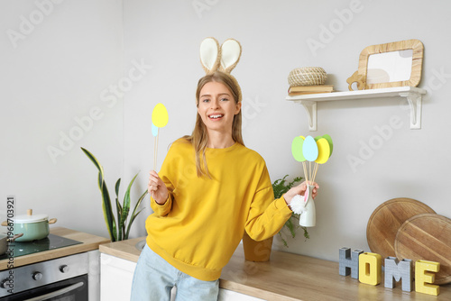 Young woman in bunny ears w...