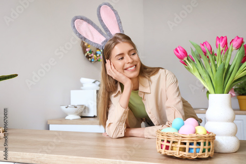 Young woman in bunny ears w...