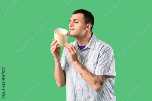 Young man with french fries...