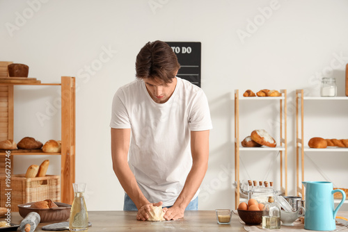 Handsome young man kneading...