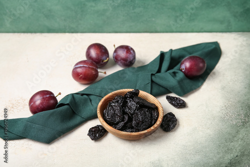 Bowl with tasty prunes and ...
