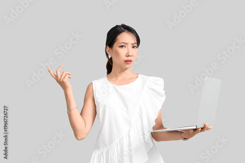 Displeased Asian businesswo...