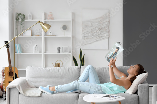 Young woman reading magazin...
