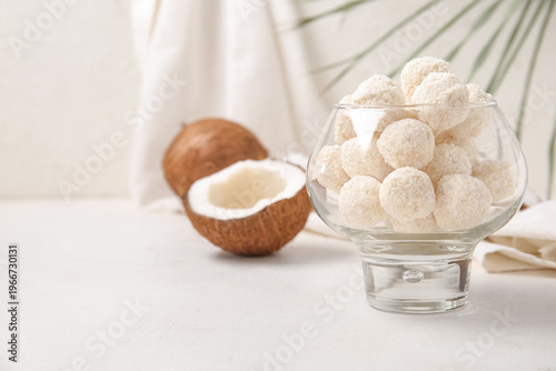 Obraz na plátně White chocolate candies with coconut topping in glass bowl on light table