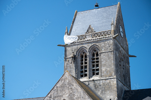 Canvas Print Close-up of paratrooper effigy hanging from Sainte-Mere-Eglise church tower Norm