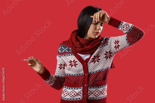 Sick young woman measuring ...