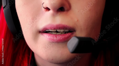 Smiling support agent wearing headset with microphone close to mouth is engaged in friendly call from home filmed in closeup. Caucasian woman is having online meeting and talking professionally