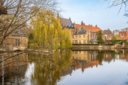 Bild auf Leinwand View of Minnewater (Lake of Love) with reflections and weeping willow, Bruges
