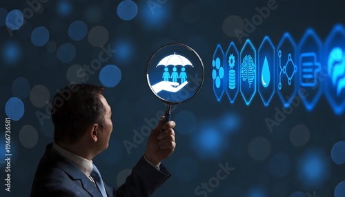 Asian businessman holding a magnifying glass over a glowing blue icon representing an umbrella protecting family, symbolizing security and insurance. Modern digital corporate background.