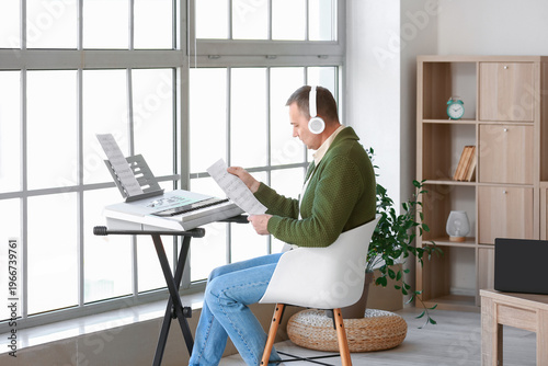 Mature man in headphones wi...