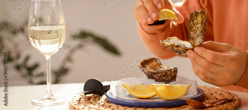 Young man squeezing lemon o...