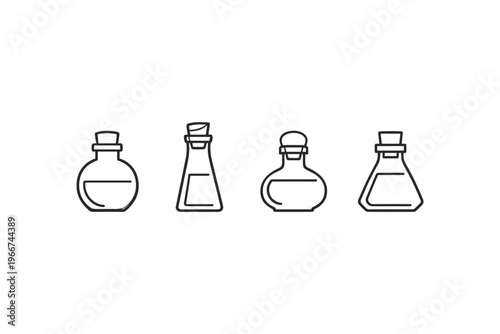 Collection of four different stylized glass bottles with cork stoppers