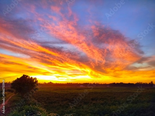 Photography Dramatic Fiery Sunset Over Rural Field with Vibrant Cloudscape