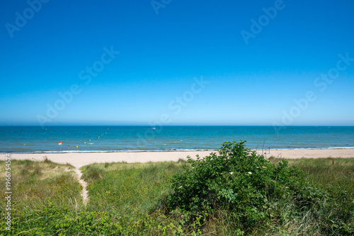 Empty sandy beach and calm sea on Normandy coast
